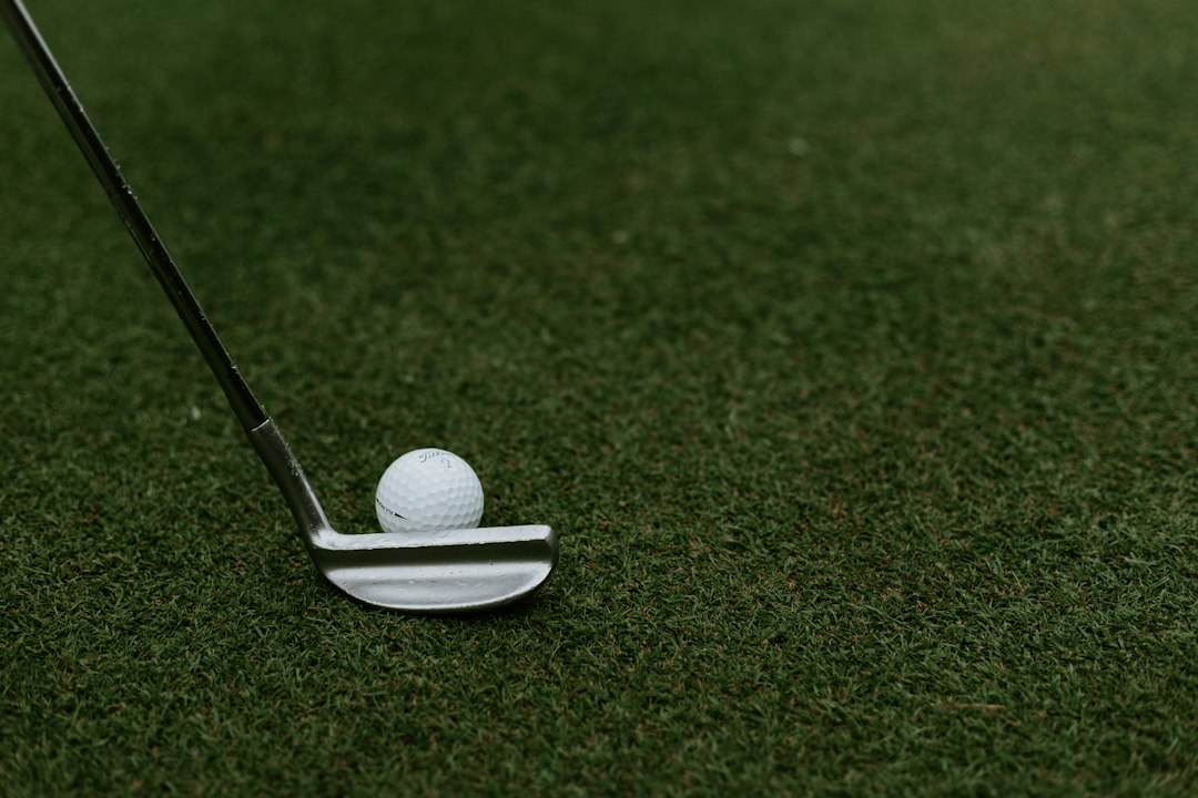 A golf club and ball on the grass at a UK course