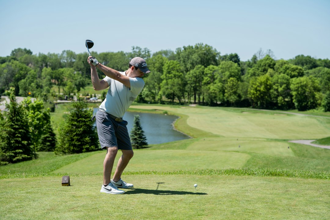 A golfer playing an iron shot on the fairway