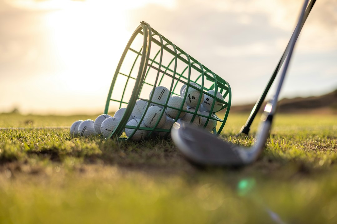 Golf clubs and balls on a driving range